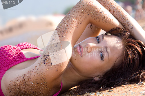 Image of Portrait of a young blue-eyed woman on the sand