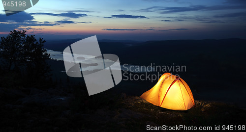 Image of A tent lit up at dusk 