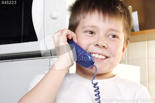 Image of Boy in white talking phone