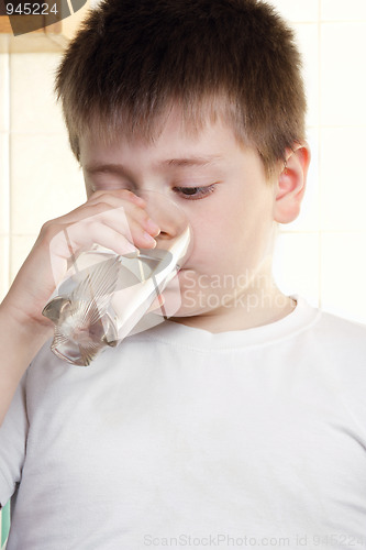 Image of Kid in white drinks water