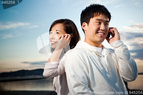 Image of Asian couple on the phone