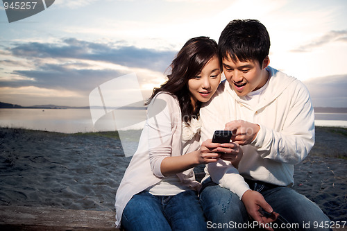 Image of Asian couple texting