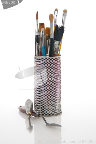 Image of Paintbrushes in a metal mesh holder