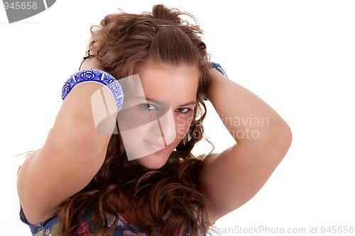 Image of beautiful young woman, holding her hair with his hands