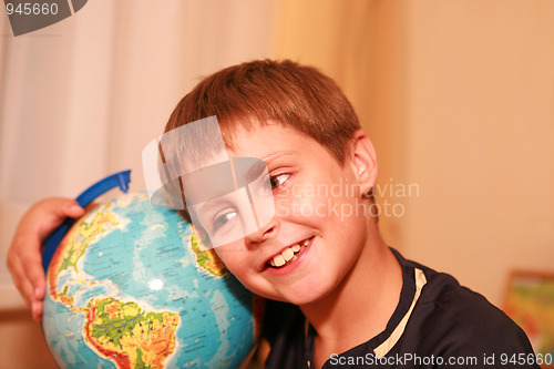 Image of boy embracing globe of world