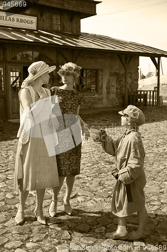 Image of homeless boy asks for money from two young women 