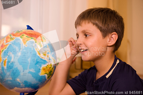 Image of boy looking globe of world 