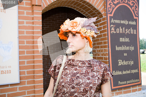 Image of Beautiful young model in hat on old city