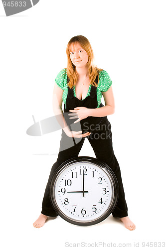 Image of pregnant woman with a clock