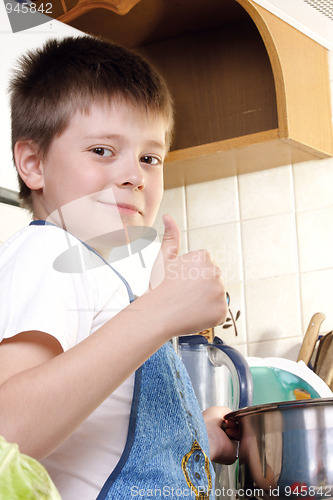 Image of Contented boy at kitchen