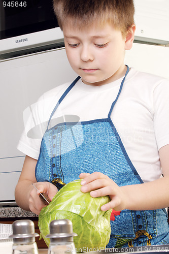 Image of Boy cutting cabbage