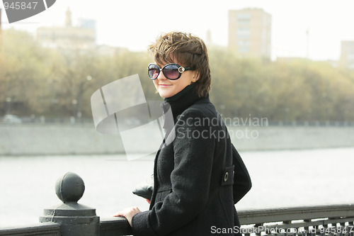 Image of Young smiling woman in sunglasses