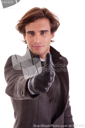 Image of Portrait of a young businessman with thumb up, in autumn/winter clothes