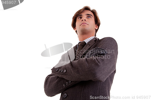 Image of Portrait of a young businessman, looking serious, in autumn/winter clothes