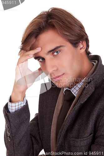 Image of Portrait of a young businessman thinking, in autumn/winter clothes,