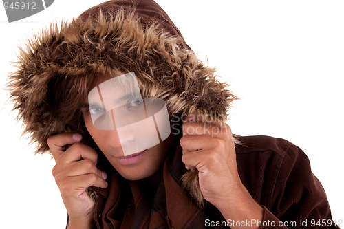 Image of Portrait of a young man with a furry hood , in autumn/winter clothes