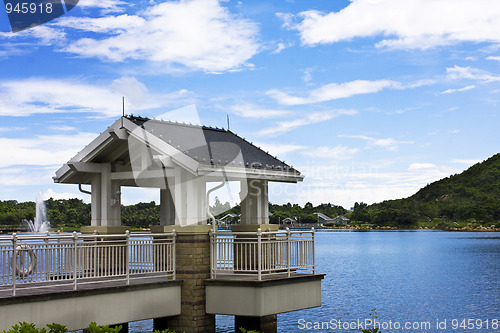 Image of Beautiful spring lake and wooden belvedere in the park.