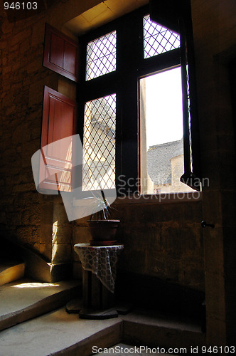 Image of Open window on stairs with plant