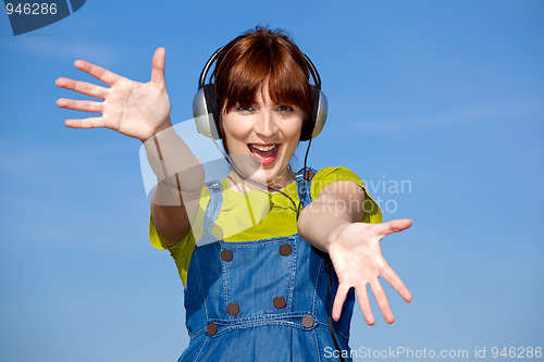 Image of Happy woman listen music