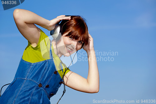 Image of Happy woman listen music