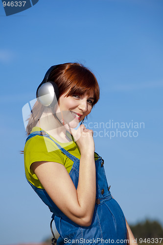 Image of Happy woman listen music