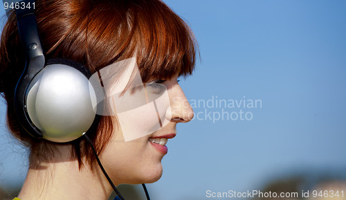 Image of Happy woman listen music