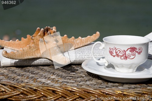 Image of coffee cup, newspaper and starfish