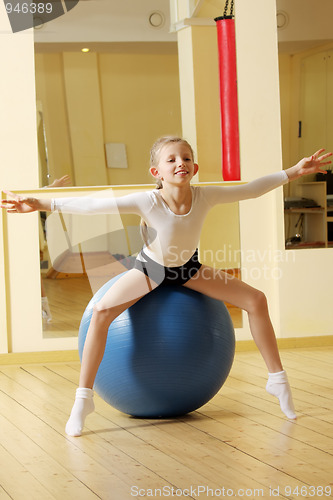 Image of Little gymnast girl on ball