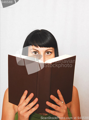 Image of Young woman reading a book.