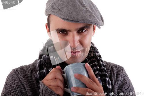 Image of Portrait of a young man, drinking a hot drink in autumn/winter clothes
