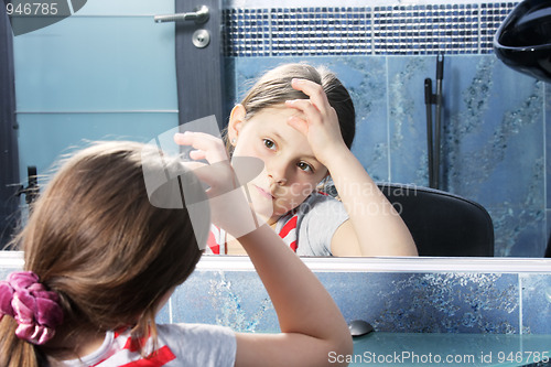 Image of Girl looking at mirror