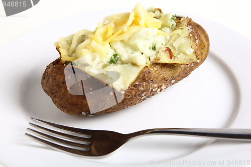 Image of Baked potato with fork on plate