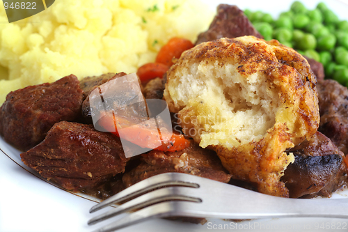 Image of Beef stew and dumplings with fork
