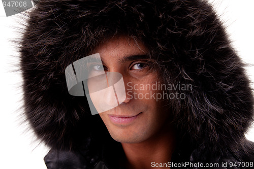 Image of Portrait of a young man with a furry hood , in autumn/winter clothes
