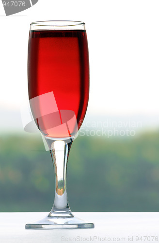 Image of glass with wine on nature background