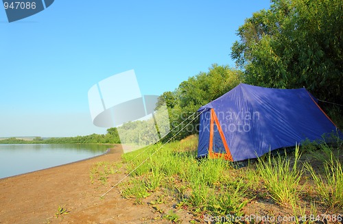 Image of tent on river beach