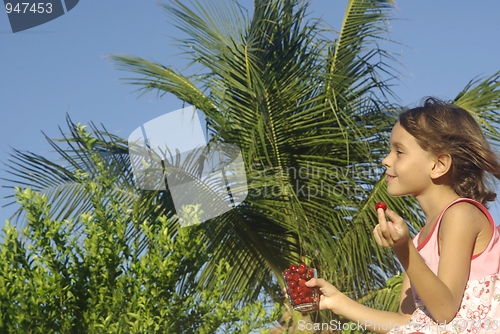 Image of CHILD EATING ACEROLA