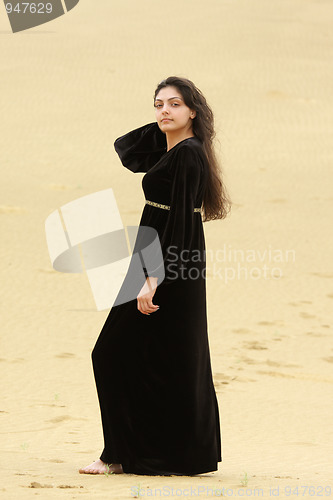 Image of Young woman in desert sideview