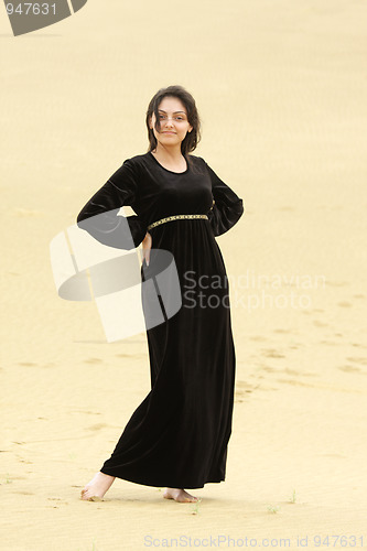 Image of Young smiling woman in desert