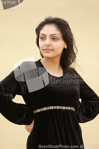 Image of Young woman in desert looking sideways