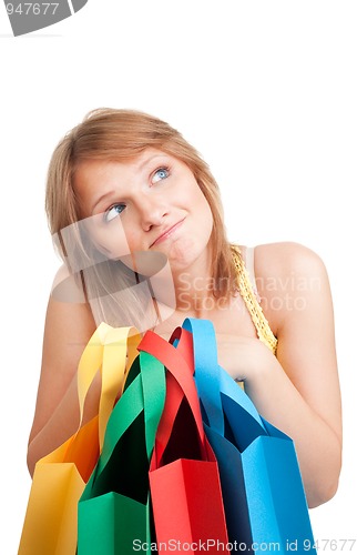 Image of Thinking woman with colorful bags