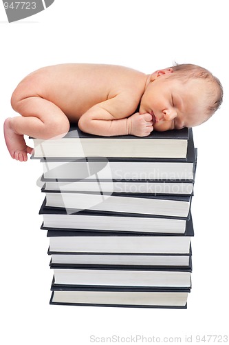 Image of newborn sleep on pile of books