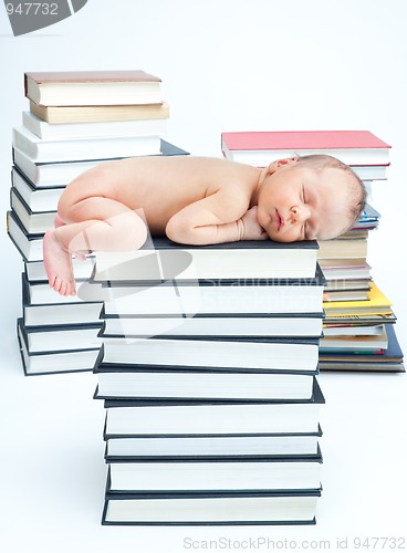 Image of New born baby sleep on books