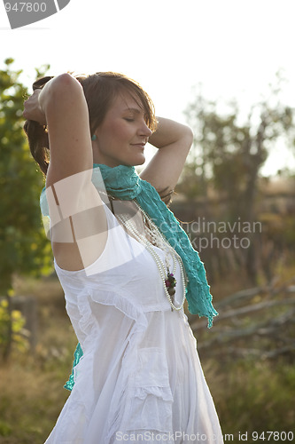 Image of Attractive woman relaxing outdoors.