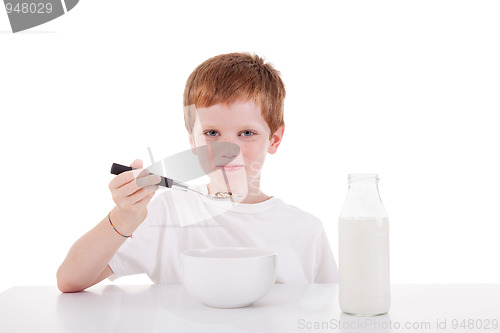 Image of cute boy taking breakfast, isolated on white