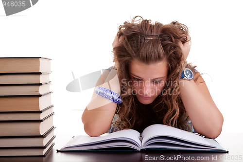 Image of girl stressed because of  work on her desk,  pulling hair