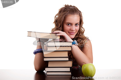 Image of happy beautiful girl , with a stack of books, and a apple,