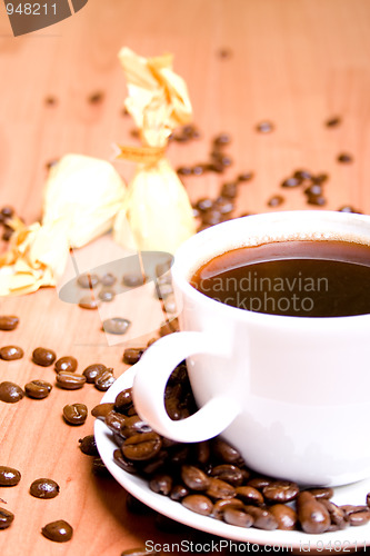 Image of coffee, some sweets and beans