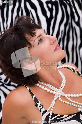 Image of beautiful woman on a zebra like background