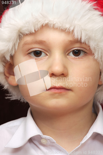 Image of Serious boy in Santa cap